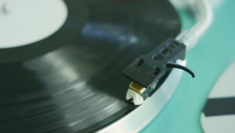 closeup of hand placing the stylus needle on record