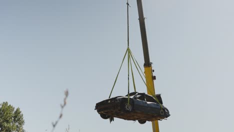 Hanging-scrapyard-junk-car-from-a-tower-crane