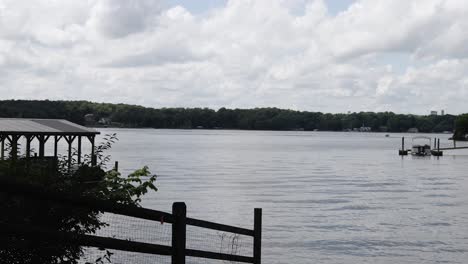 Speed-Boat-sailing-through-frame-on-a-lake-in-the-background-cloudy-blue-sky-in-North-Carolina