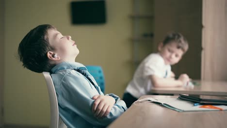 Children-do-their-homework-one-sits-at-the-table-with-notebooks