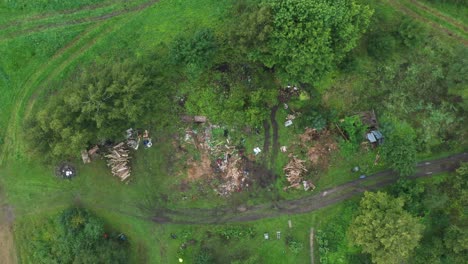 Aerial-top-down-view-of-summer-countryside-yard-cleaning-family-gathering