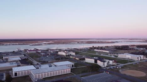 a beautiful aerial drone shot, flying towards the horizon during the golden hour in cape may new jersey, cape may county