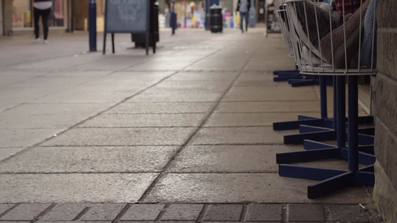 Shoppers walking through high street low angle shot