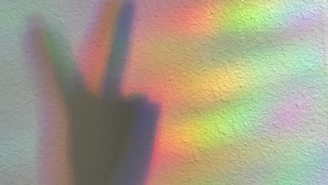 Shadow-of-a-Peace-symbol-casted-onto-a-rainbow-light-background