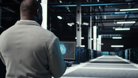 vertical video server room admin using laptop to do infrastructure ai automatization