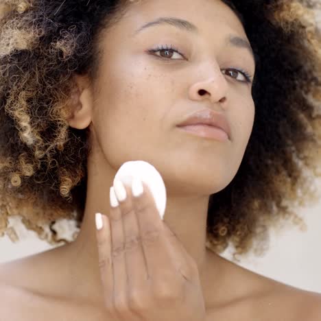 young woman cleaning skin