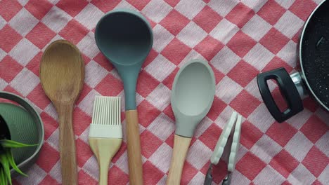 colorful kitchen utensils on checkered tablecloth