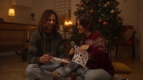 couple making christmas decorations together
