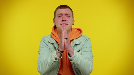 teen student man praying, looking upward and making wish, asking god for help, begging apology
