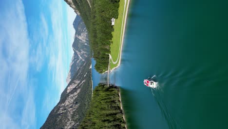 Vertical-drone-shot-boat-sailing-on-lake-in