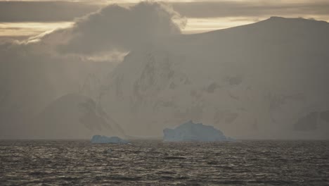 Evening-or-morning-golden-sun-shining-on-coastline-in-Antarctica-with-snow-and-ice