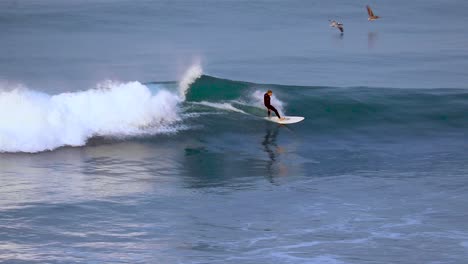 un surfista irreconocible surfeando sobre una ola en carlsbad.