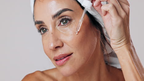 woman applying facial serum