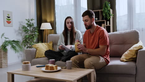 couple sitting on the sofa at home