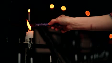 lighting a candle in a church