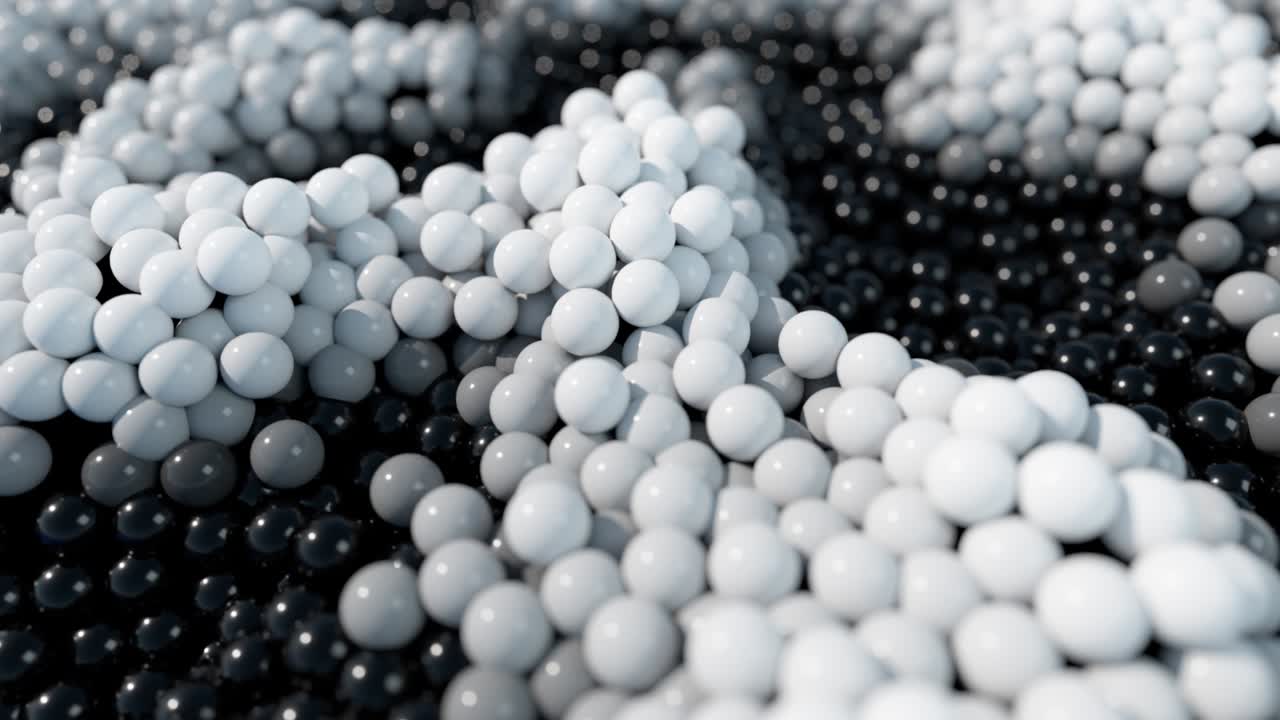 움직이는 파도 표면에 있는 동적 검은색과 색의 공.