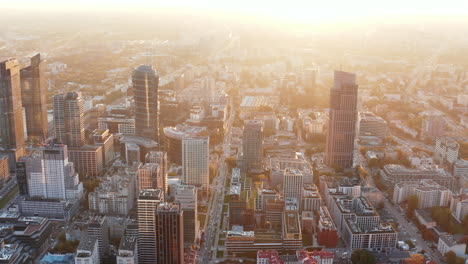 Aerial-panoramic-footage-of-high-rise-downtown-buildings.-Shot-against-morning-glowing-sun.-Warsaw,-Poland