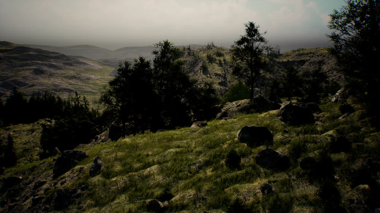 Lush green hillside and distant mountains under cloudy sky at midday