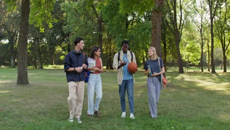 group of diverse students walking in a park