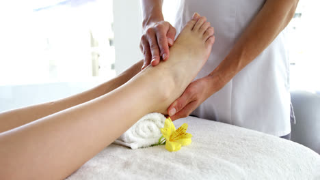 close up of woman therapist massaging the feet of her patient