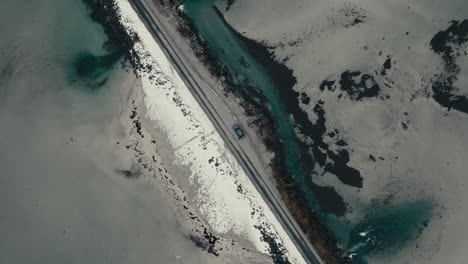 overhead view of car parked on the side of the road along the sea in lofoten, norway. - aerial shot