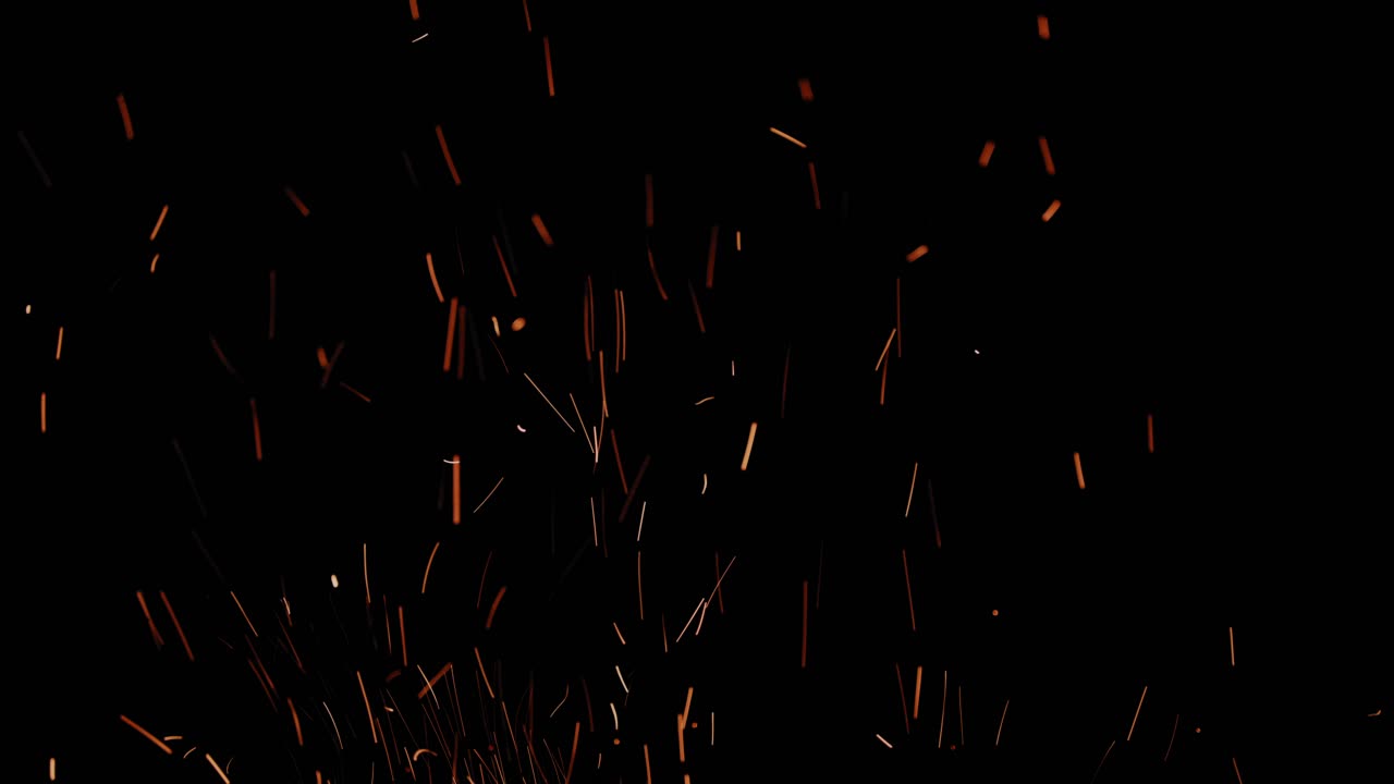 muchas chispas largas volando hacia arriba muy rápido con fondo negro