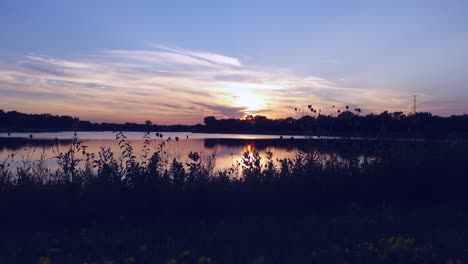 sunset on the lake, early evening with foliage in foreground, no persons