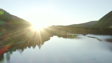 4k aerial drone footage of a sunrise over a lake in the rocky mountains of colorado in the autumn or fall with changing aspen trees