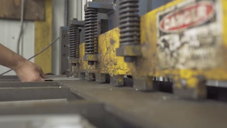 shearing aluminum on a metal shear during manufacturing production