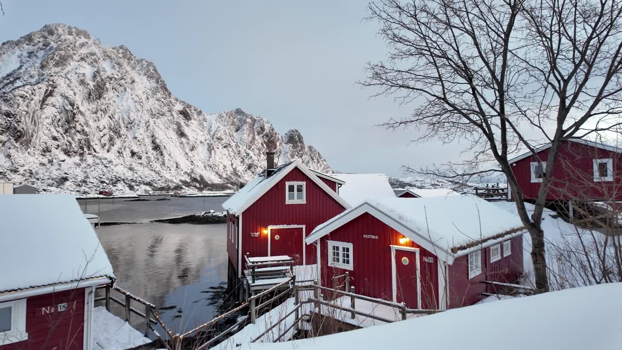 Winter cabins by the fjord, surrounded by snow, with scenic mountains in Svolvær