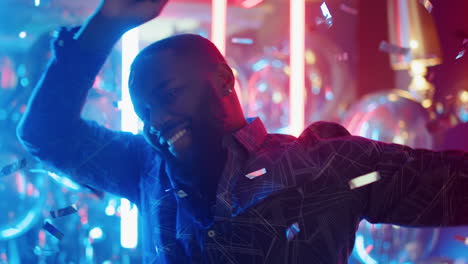 african american guy having fun on neon lamps background. man dancing in club