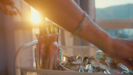 Artist Working on Art Supplies at Sunset