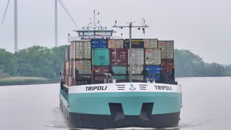 huge fully loaded container ship on inland river, showcasing international trade export and import business