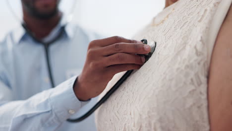 doctor examining patient's chest with stethoscope