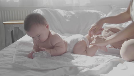 Cute-Baby-And-Happy-Mom-In-Bed-Close-Up