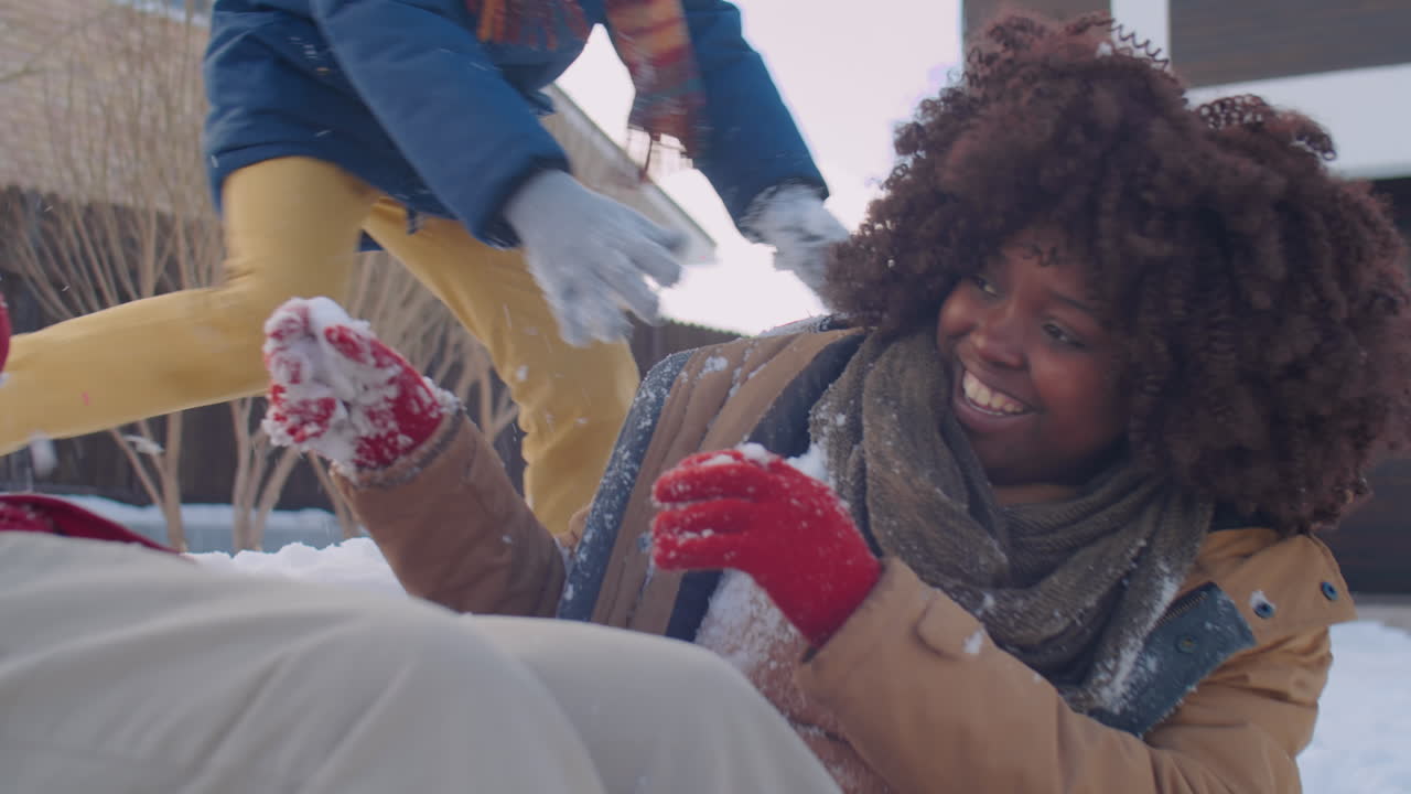 Parents and Little Son Playing Snowballs and Having Fun Outside