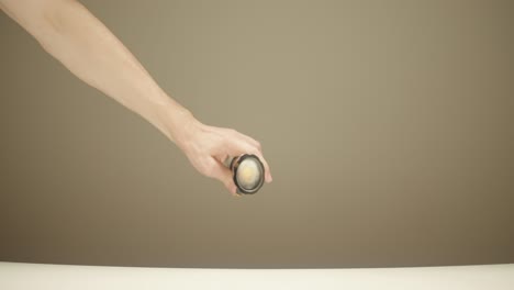 hand holding a flashlight and hand spinning a fidget spinner