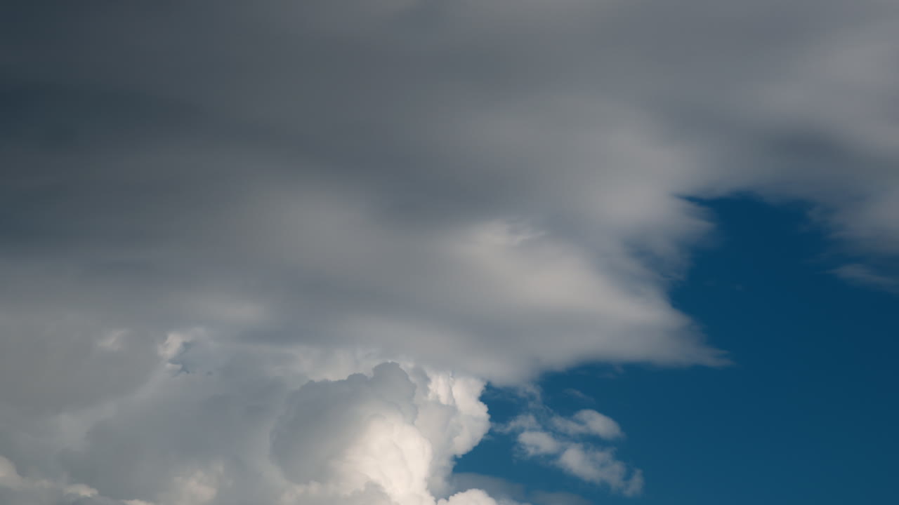 Scenic time lapse of clouds moving on a sunny day with a bright blue sky in the background