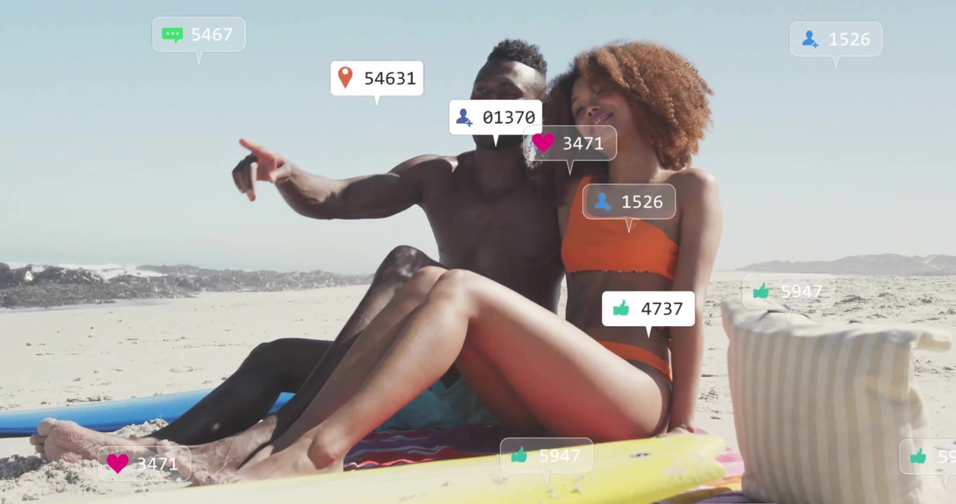 man and woman leaning back gazing at ocean as social media reaction bubbles rising around surfboard