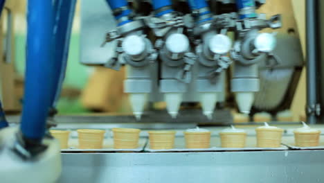 food processing equipment. waffle cones filling with ice cream. production line