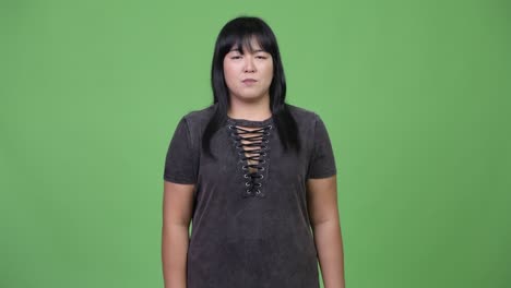 happy overweight asian woman giving thumbs up