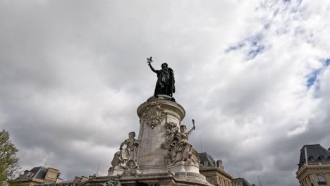 people walking near a parisian statue