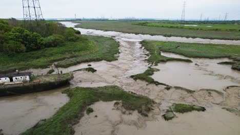 aerial view of a decayed boat stuck in the marsh at wat tyler country park, basildon, uk - tracking, drone shot