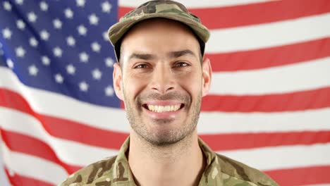 Soldier-standing-in-front-of-American-flag