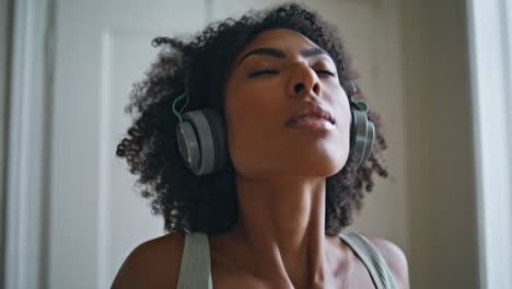 Closeup-tranquil-woman-breathing-deeply.-African-lady-making-exercises-at-home