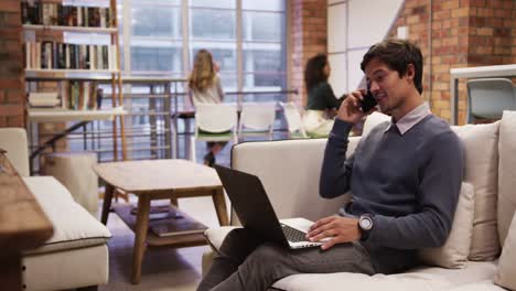 creative businessman using laptop in modern office