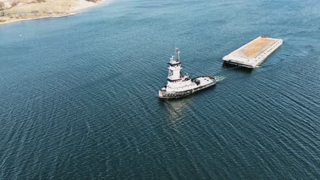 a tug headed toward lake michigan through the muskegon channel