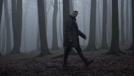 man walking in a foggy forest