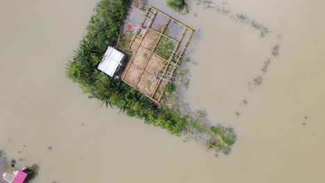 aerial view of floating houses surrounded by flood water in bangladesh, south asia
