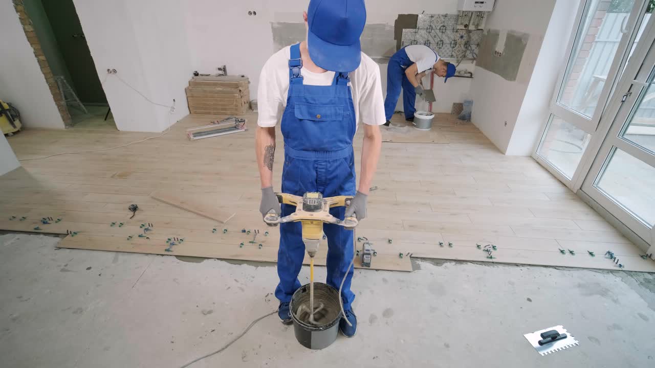 Construction, renovation, repair apartment. Installing ceramic floor tiles - measuring and cutting the pieces. Cuts tile. Tile cutting